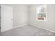Neutral bedroom with plush carpet, featuring natural light and a standard door at 528 6Th St, Chester, SC 29706