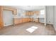 Bright kitchen featuring new wooden cabinets, new countertops, and wood grain vinyl floors at 528 6Th St, Chester, SC 29706