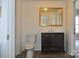 Bathroom features a toilet, vanity with marble countertop, gold-trimmed mirror, and vinyl floors at 529 Gage St, Chester, SC 29706