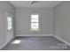 A bedroom with white walls, grey carpeting, and natural light at 529 Gage St, Chester, SC 29706