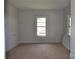 A bedroom with white walls, tan carpeting, and a single window at 529 Gage St, Chester, SC 29706