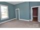 A bedroom with teal walls, tan carpeting, and lots of natural light at 529 Gage St, Chester, SC 29706