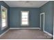 This bedroom features teal walls, tan carpeting, and a white ceiling fan at 529 Gage St, Chester, SC 29706