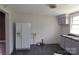 This kitchen features a white refrigerator, grey cabinets, and dark flooring at 529 Gage St, Chester, SC 29706