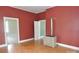 An open-concept living room with red walls and wood floors at 529 Gage St, Chester, SC 29706