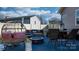 Outdoor living space featuring a cozy seating area, fire pit, and hot tub for relaxation and entertaining at 5324 Stonewood Dr, Hickory, NC 28602