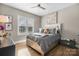 Cozy bedroom with natural light, hardwood floors, plush queen bed, and charming decor at 5324 Stonewood Dr, Hickory, NC 28602