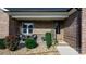 Close-up of the front porch featuring a seating area, decorative plants, and a 'Welcome' sign at 5324 Stonewood Dr, Hickory, NC 28602