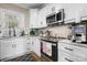 Modern kitchen with white cabinets, stainless steel appliances, and black hardware at 5324 Stonewood Dr, Hickory, NC 28602
