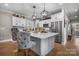 Bright kitchen featuring an island with marble countertop, stainless steel appliances, and hardwood floors at 5324 Stonewood Dr, Hickory, NC 28602