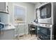 Bright laundry room features modern, stacked washer and dryer, a window and a small workstation at 5324 Stonewood Dr, Hickory, NC 28602