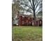 Classic red brick home with a lush green backyard and mature trees offering plenty of shade at 55 Academy Nw Ave, Concord, NC 28025