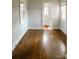 Sun-filled bedroom with wood floors, white walls and natural light at 55 Academy Nw Ave, Concord, NC 28025