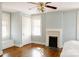 Bright bedroom with hardwood floors, white trim, a fireplace, and a ceiling fan at 55 Academy Nw Ave, Concord, NC 28025