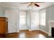 Spacious bedroom with hardwood floors, white trim, and natural light from multiple windows at 55 Academy Nw Ave, Concord, NC 28025