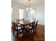 Traditional dining room with a large table, hardwood floors, and chandelier lighting at 55 Academy Nw Ave, Concord, NC 28025