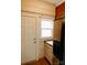 Kitchen area including stainless fridge, door to the exterior and white cabinets at 55 Academy Nw Ave, Concord, NC 28025