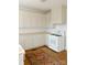 Bright kitchen with wooden floors, white cabinets, wooden countertops, and white appliances at 55 Academy Nw Ave, Concord, NC 28025