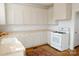 Classic kitchen with white cabinets, wood countertops, and modern white appliances at 55 Academy Nw Ave, Concord, NC 28025