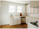 Bright kitchen with white cabinets, butcher block counters, apron sink, and stainless steel dishwasher at 55 Academy Nw Ave, Concord, NC 28025