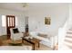 Bright living room featuring hardwood floors, a red entry door and white furniture at 55 Academy Nw Ave, Concord, NC 28025