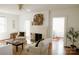 Bright living room featuring a fireplace, neutral furniture, and hardwood floors at 55 Academy Nw Ave, Concord, NC 28025
