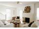 Bright living room featuring a white brick fireplace, light walls, hardwood floors and white furniture at 55 Academy Nw Ave, Concord, NC 28025