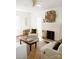 Bright living room featuring a white brick fireplace, light walls, hardwood floors and white furniture at 55 Academy Nw Ave, Concord, NC 28025