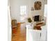 Bright living room featuring a white brick fireplace, light walls, hardwood floors and white chair at 55 Academy Nw Ave, Concord, NC 28025