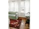 Bright sitting room featuring a patterned sofa, area rug, and lots of natural light at 55 Academy Nw Ave, Concord, NC 28025