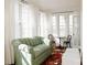 Bright sitting room featuring a patterned sofa, area rug, and lots of natural light at 55 Academy Nw Ave, Concord, NC 28025