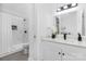 Bathroom featuring shower with marble tile, modern vanity, and sleek black fixtures at 608 Picketts Cir, Indian Trail, NC 28079