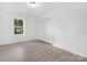 Bedroom showcasing neutral color palette, laminate flooring, and window with natural light at 608 Picketts Cir, Indian Trail, NC 28079