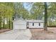 Charming home featuring mature trees, white siding, attached garage, and concrete driveway at 608 Picketts Cir, Indian Trail, NC 28079