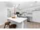Modern kitchen with island seating, gray cabinets, stainless appliances, and quartz countertops at 608 Picketts Cir, Indian Trail, NC 28079