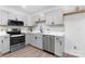 Bright kitchen featuring gray cabinets, stainless appliances, and quartz countertops at 608 Picketts Cir, Indian Trail, NC 28079