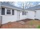 Backyard exterior of the house with white siding and black window shutters at 63 3Rd Nw St, Concord, NC 28027