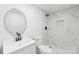 Bathroom features a modern vanity, toilet, and shower with marble tiling and black fixtures at 63 3Rd Nw St, Concord, NC 28027