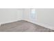 Cozy bedroom with light wood-look floors, fresh paint, and one window at 63 3Rd Nw St, Concord, NC 28027