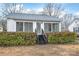 Home exterior featuring trimmed hedges, siding, large windows, and a small staircase at 63 3Rd Nw St, Concord, NC 28027