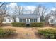 Charming home exterior with siding, trimmed hedges, staircase and gravel entry at 63 3Rd Nw St, Concord, NC 28027