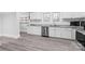 Bright kitchen features stainless appliances, gray counters and backsplash, and white cabinetry at 63 3Rd Nw St, Concord, NC 28027