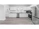 Bright kitchen with white cabinets, stainless steel appliances, and granite countertops at 63 3Rd Nw St, Concord, NC 28027