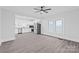 Bright living room with a ceiling fan and an open floor plan that flows into the kitchen at 63 3Rd Nw St, Concord, NC 28027