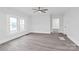 Living room featuring natural light, wood look flooring and a ceiling fan for added comfort at 63 3Rd Nw St, Concord, NC 28027