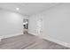 Spacious living room with wood-look flooring, neutral paint and an open doorway to the kitchen at 63 3Rd Nw St, Concord, NC 28027