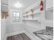 Pantry room features shelving and granite counters, next to the kitchen at 63 3Rd Nw St, Concord, NC 28027