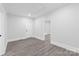 A room with wood look flooring, recessed lighting and access to other rooms in the home at 63 3Rd Nw St, Concord, NC 28027