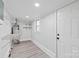 Clean storage room with shelves, a window, and a new door at 63 3Rd Nw St, Concord, NC 28027