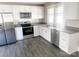 Bright kitchen features white cabinets, stainless steel appliances, and granite countertops at 7105 Nc Hwy 73 E Hwy, Mount Pleasant, NC 28124